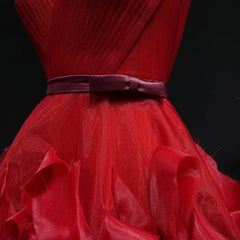 Red dress with a large bow on a black background