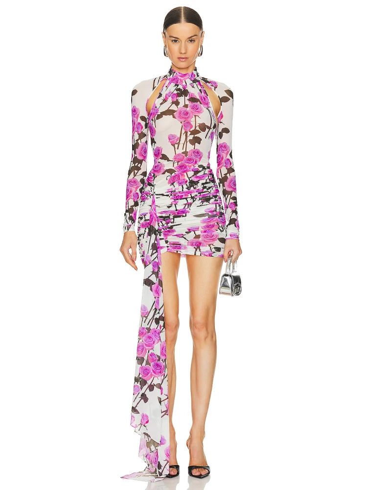 Model wearing a floral dress with a high slit on a white background.