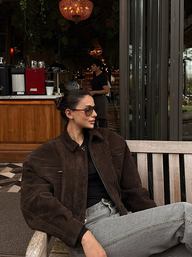 Woman sitting on a bench in a cafe setting