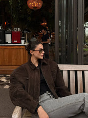 Woman sitting on a bench in a cafe setting