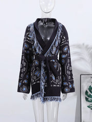 Black cardigan with blue paisley pattern on a mannequin against a white background
