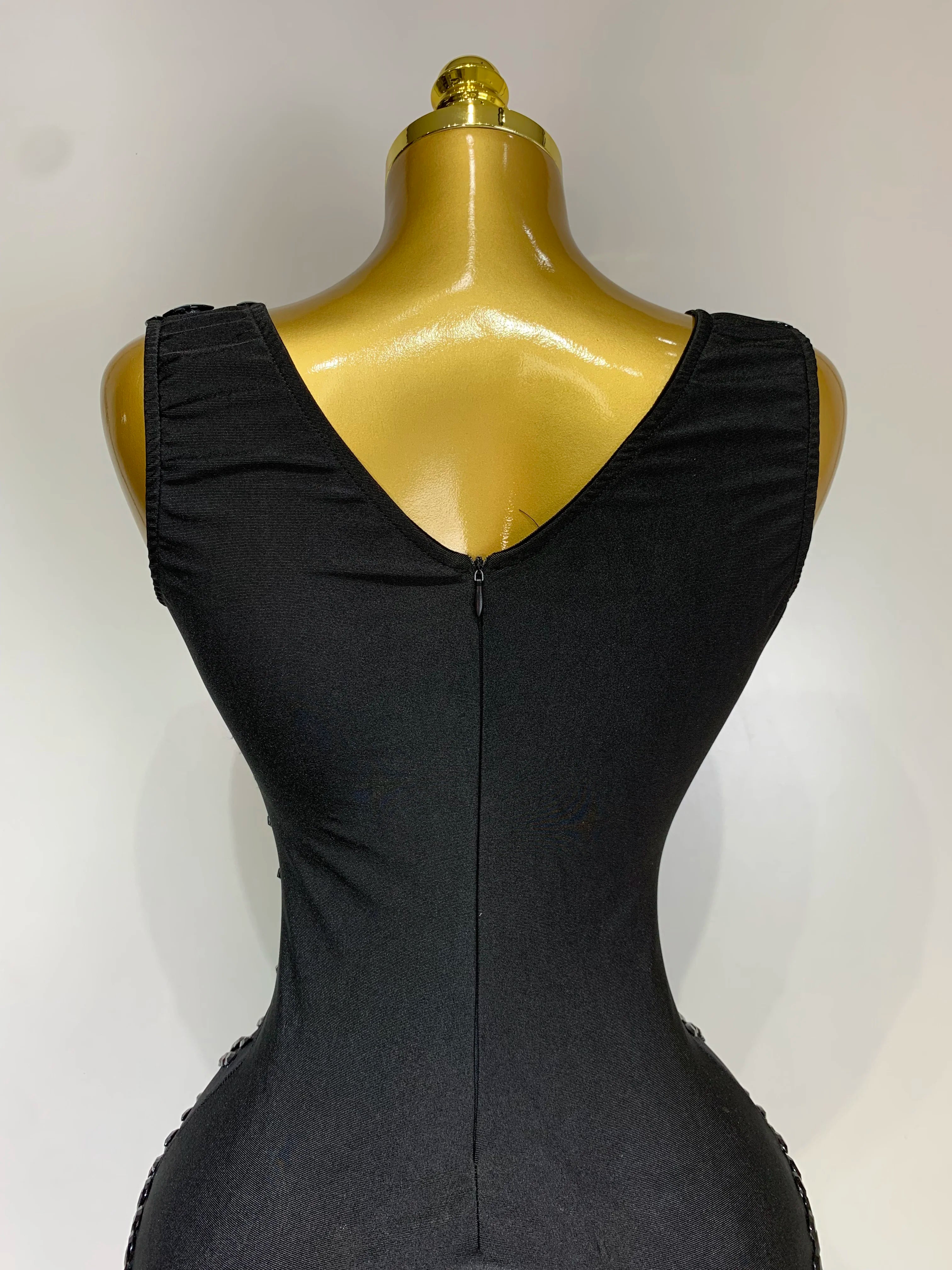 Black dress on a mannequin against a white background