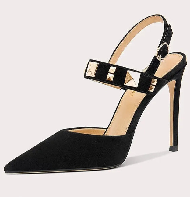 Black high-heeled shoe with studded detail on a light gray background