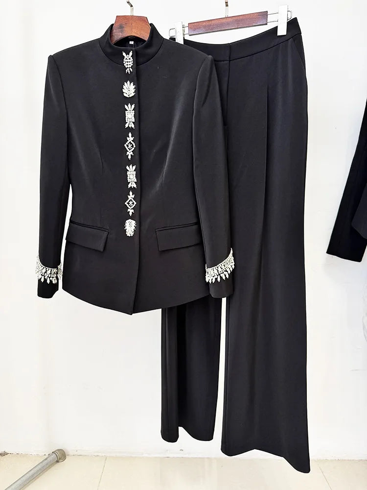 Black embellished stand collar jacket and wide leg pants suit displayed on hangers