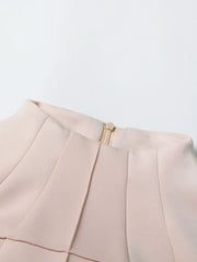 Close-up of a beige garment with a zipper on a light gray background