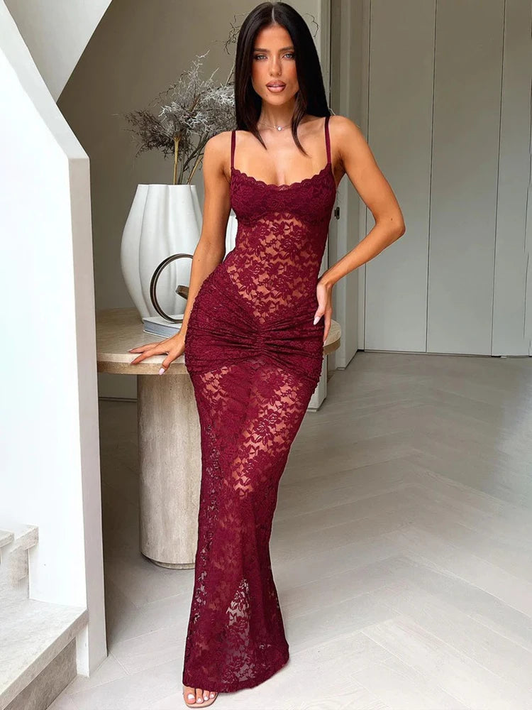 Woman wearing a burgundy lace dress in an indoor setting