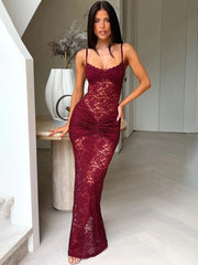 Woman wearing a burgundy lace dress in an indoor setting