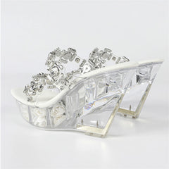 High-heeled shoe with crystal embellishments on a white background