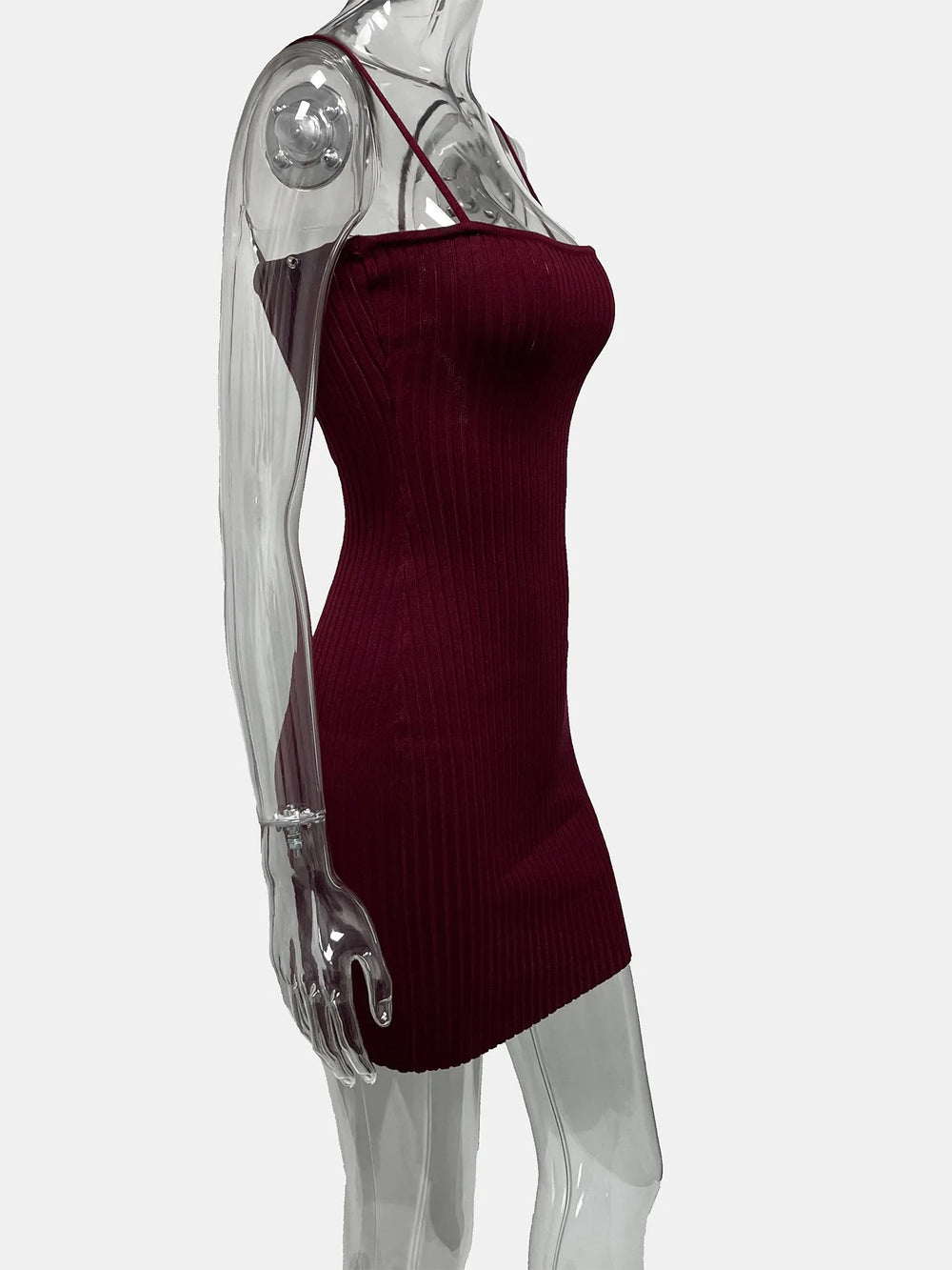 Red ribbed dress on a transparent mannequin against a white background