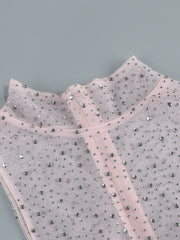 Gray fabric with small embellishments on a gray background