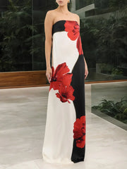 Woman wearing a strapless dress with red floral patterns in a modern indoor setting