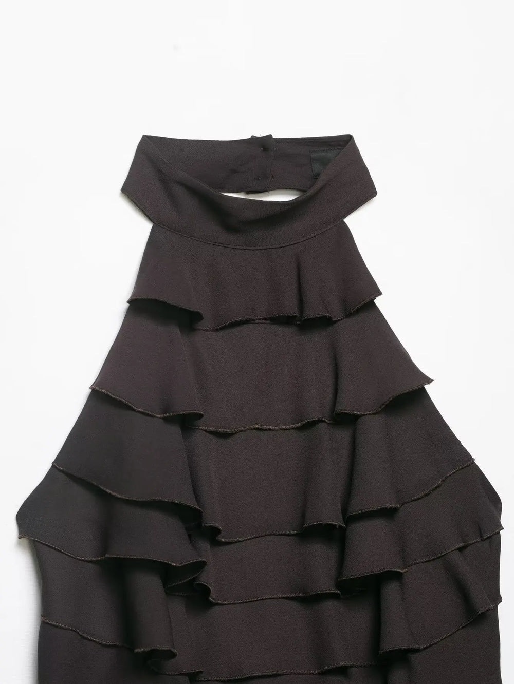Black ruffled dress on a white background