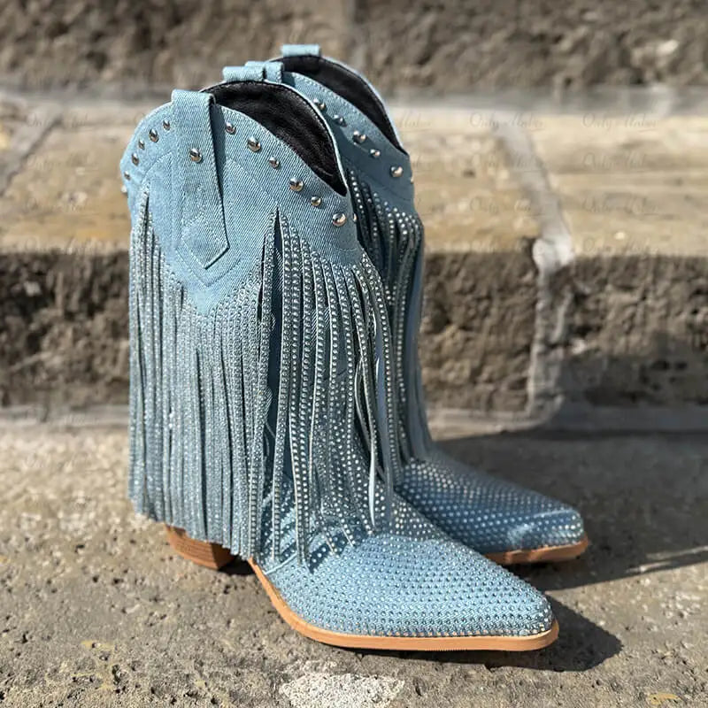 Pair of blue fringed boots on a stone surface