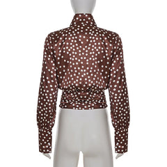 Back view of blouse illustrating lantern sleeve shaping and relaxed torso structure.