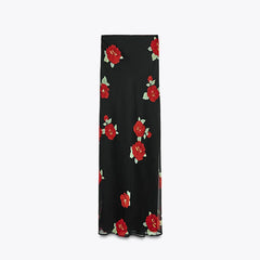 Black skirt with red floral pattern on a white background