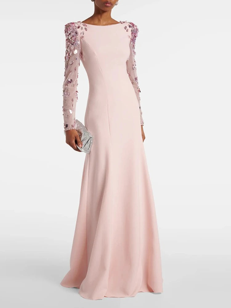 Pink evening gown with floral sleeves on a white background