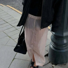 Sheer pleated slit midi skirt near lamppost