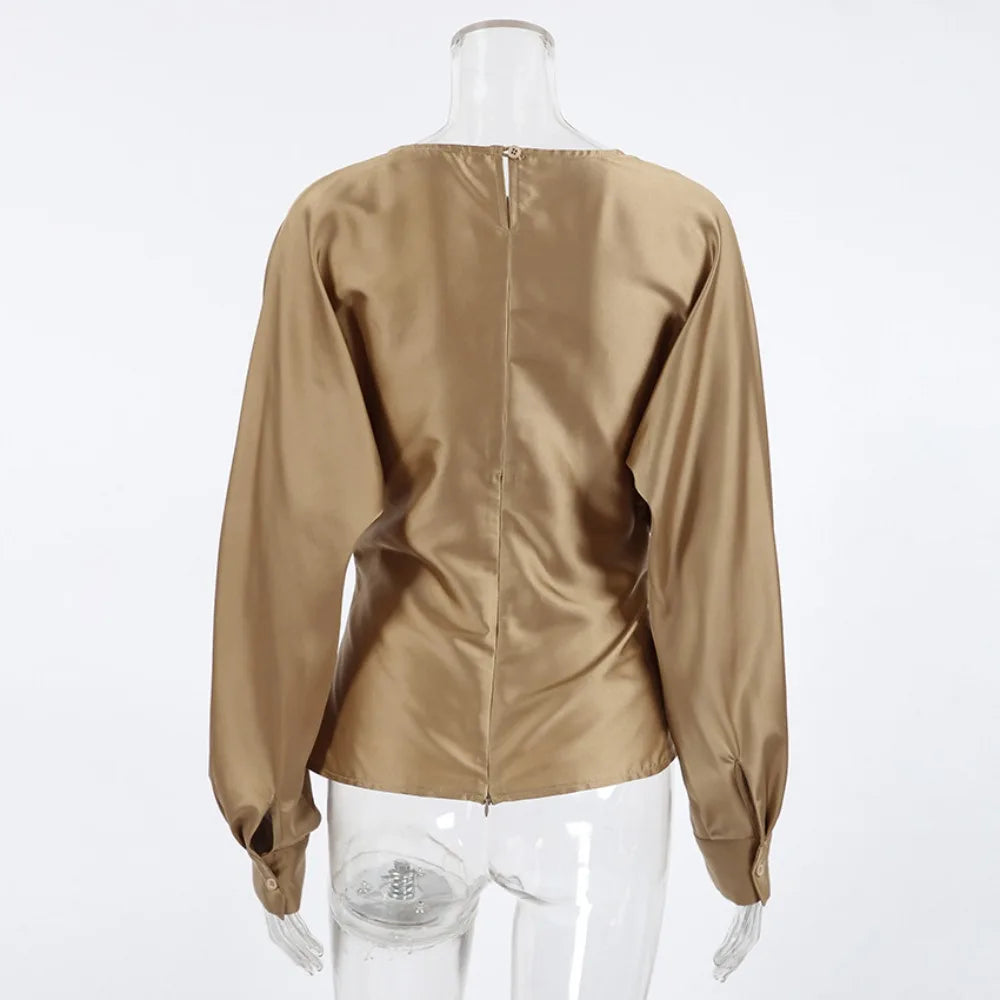Beige blouse on a mannequin against a white background