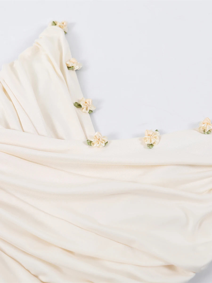 Beige fabric with floral embellishments on a light gray background