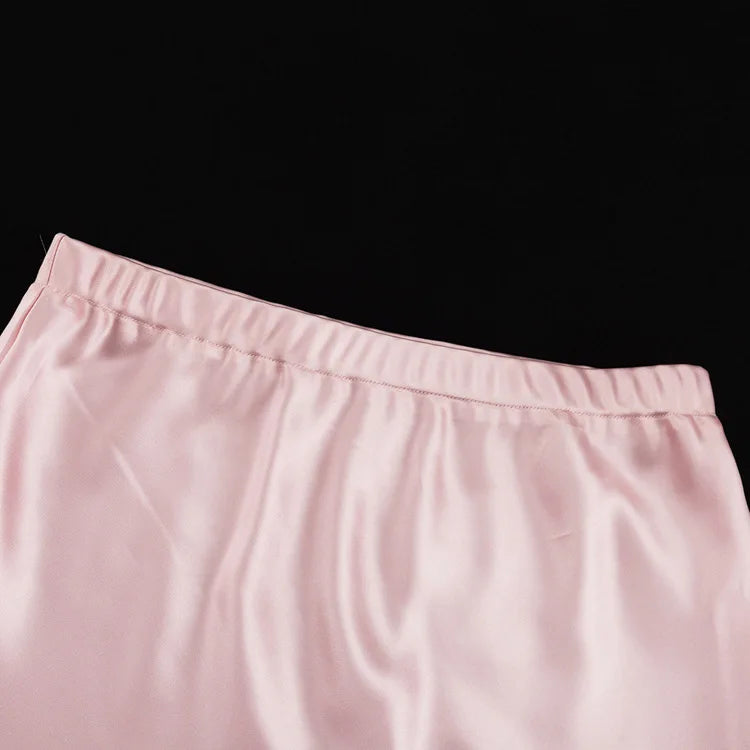 Close-up of pink pants with a black background