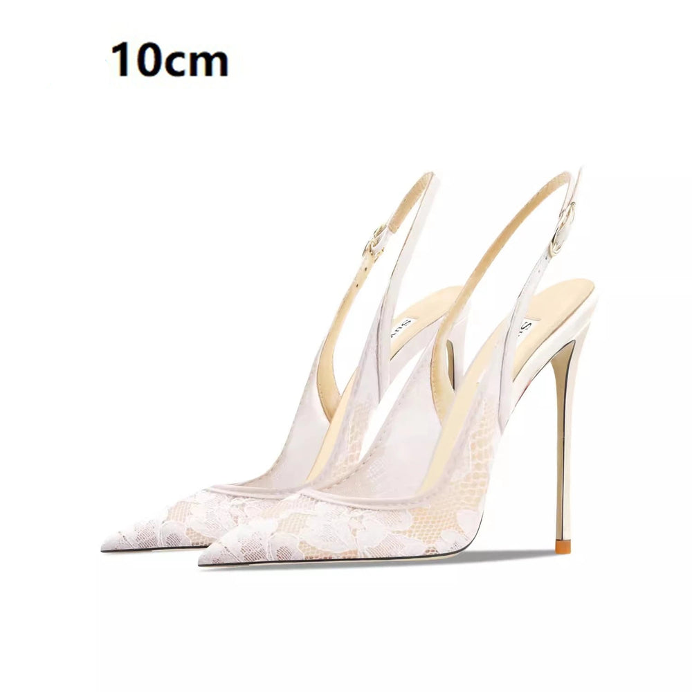 White high-heeled shoes with gold accents on a white background