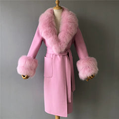 Pink coat with fur trim on a mannequin against a gray background