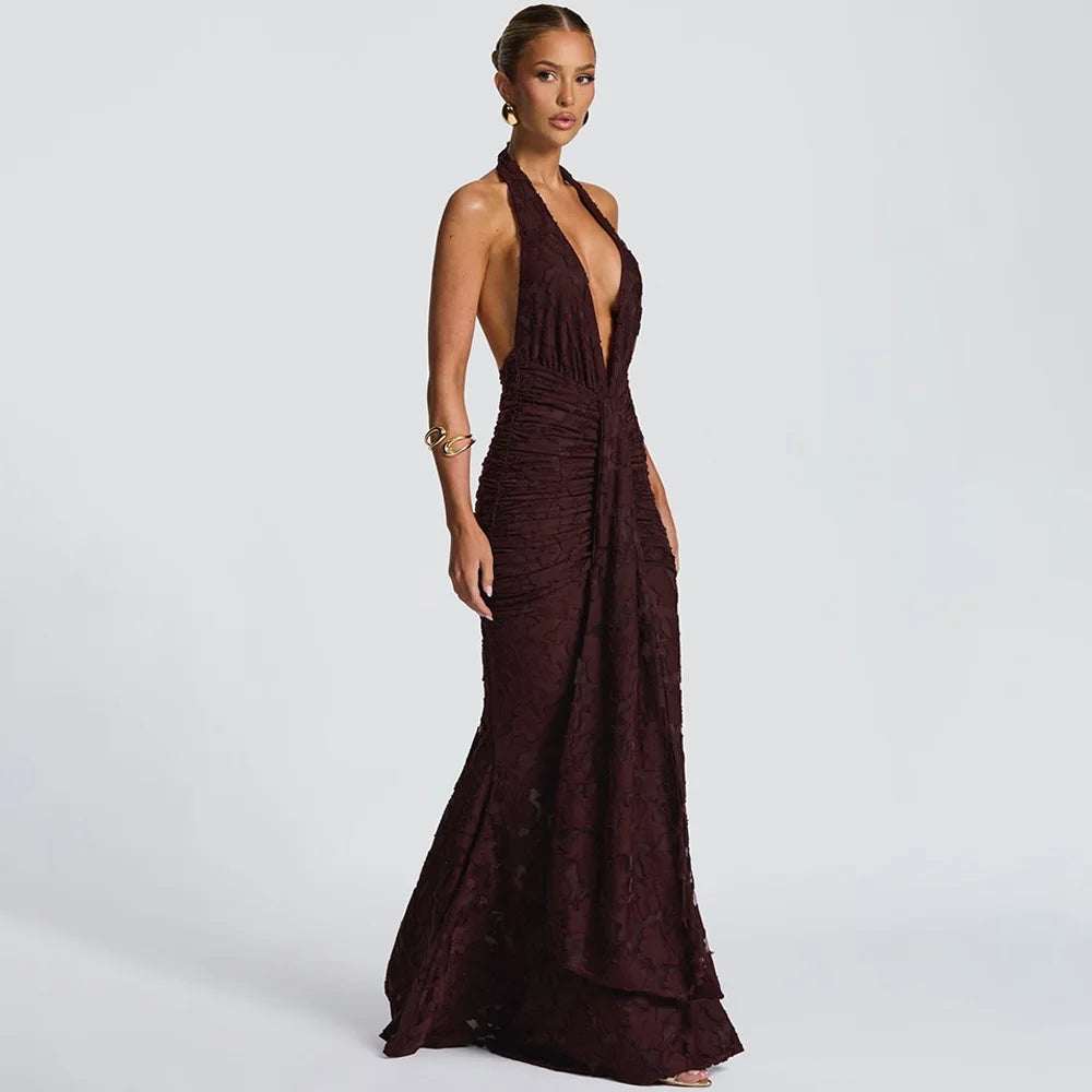 Woman wearing a burgundy evening gown on a light gray background