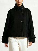 High neck solid cropped jacket with asymmetrical button closure and cuffed sleeves.