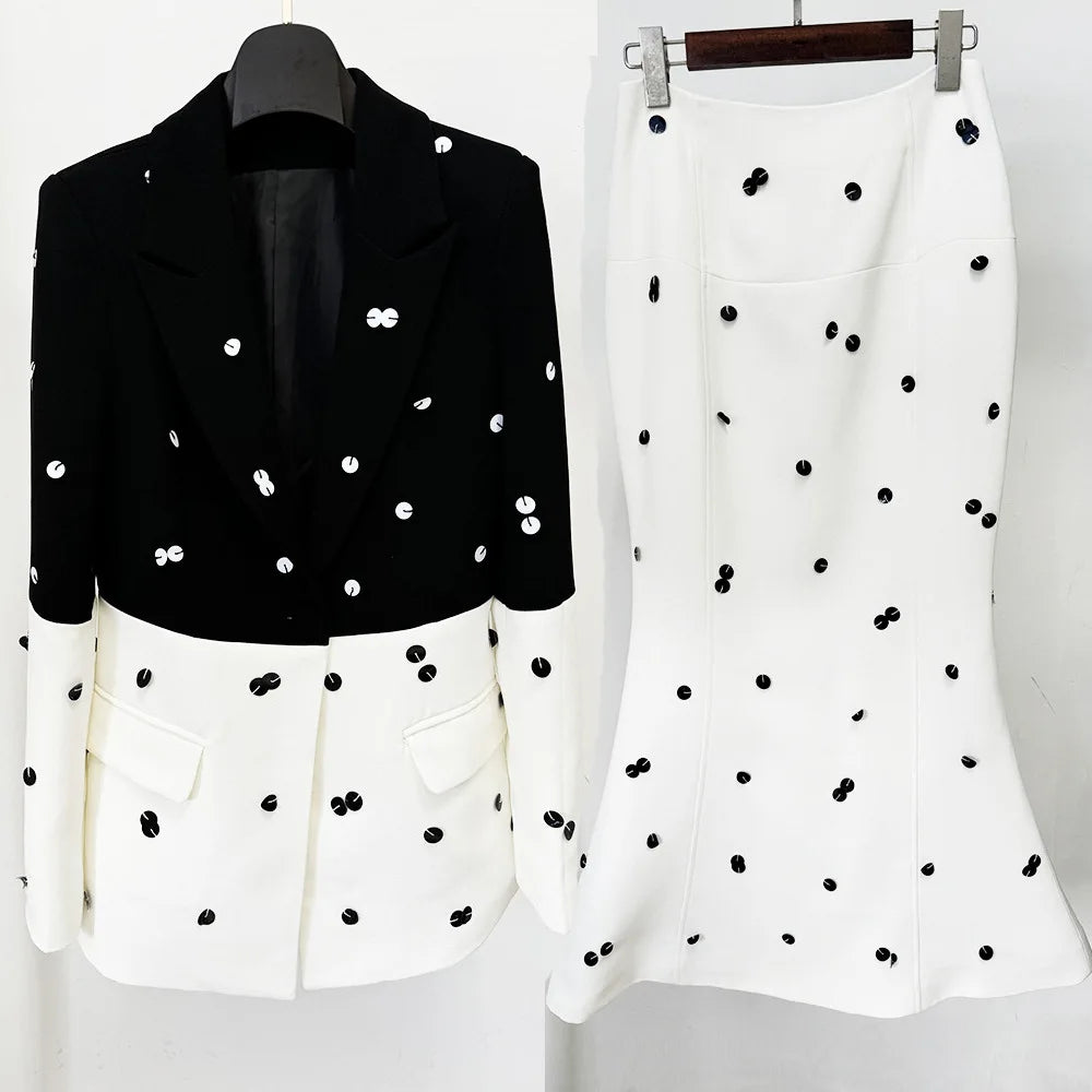 Black and white outfit with polka dot pattern on a plain background