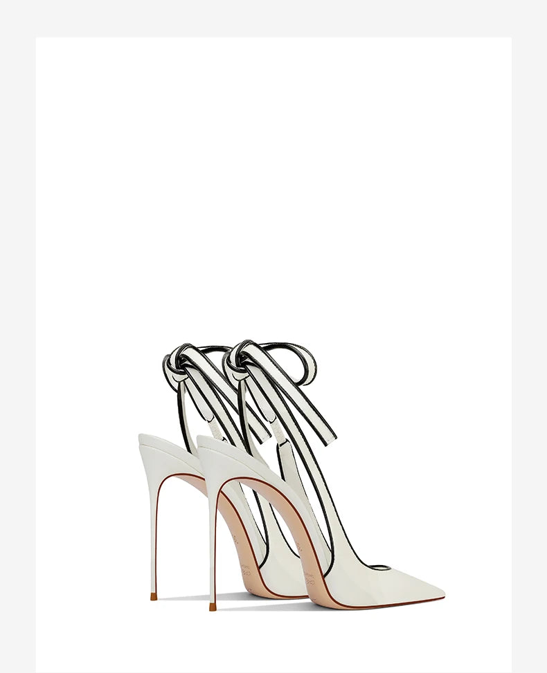 White high-heeled shoes with clear straps on a white background