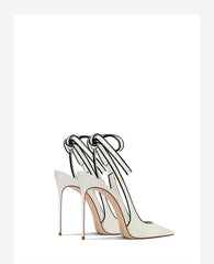 White high-heeled shoes with clear straps on a white background