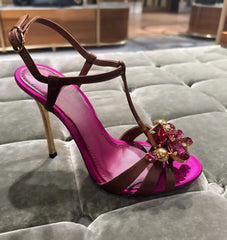 Single crystal embellished t-strap stiletto heel on a plush surface