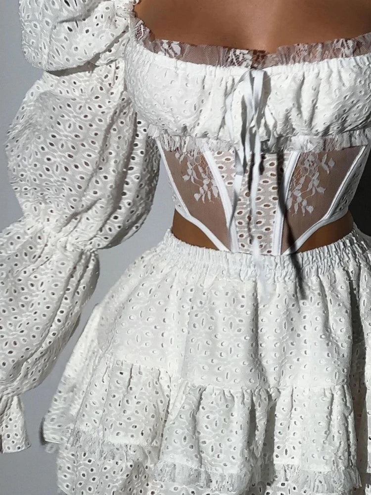 White lace top and skirt set with sheer details on a neutral background