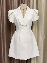 White dress on a mannequin against a plain background