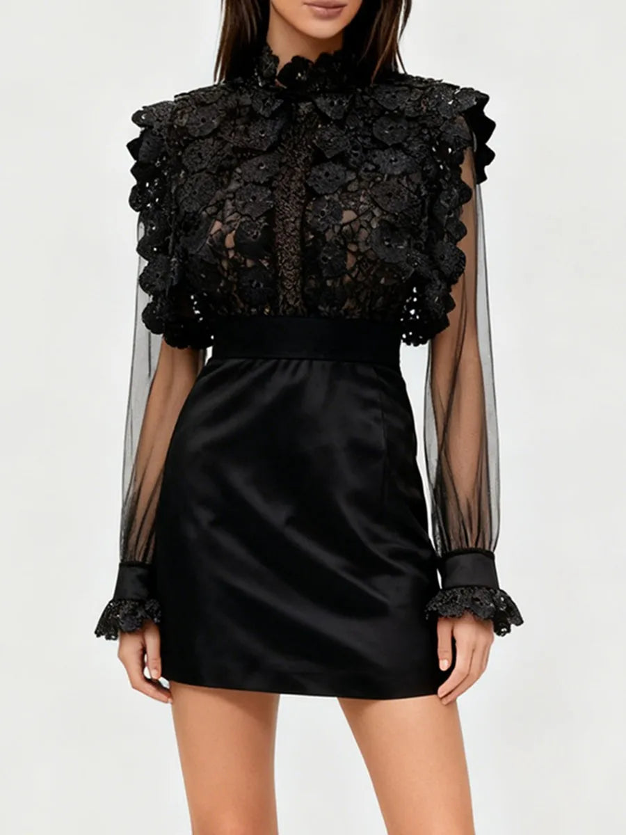Black lace top with sheer sleeves and a black skirt on a white background