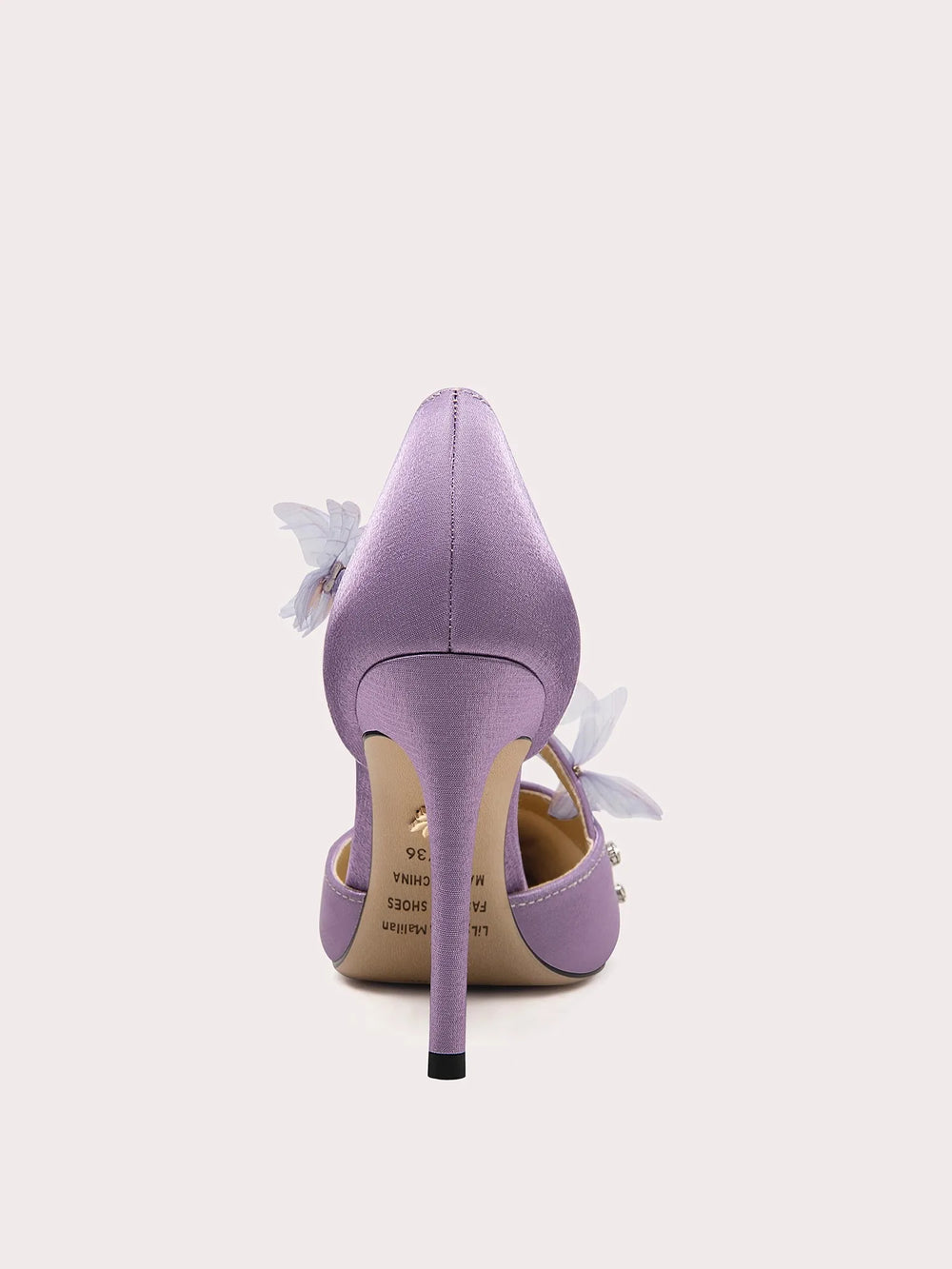 Purple high-heeled shoe with floral details on a white background
