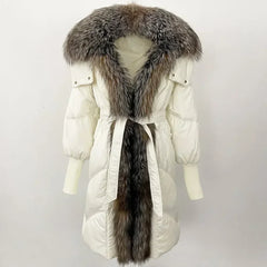 White winter coat with fur hood and tail on a mannequin against a white background