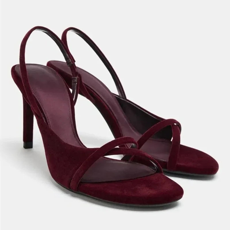 Side view of burgundy velvet cross strap stiletto heel