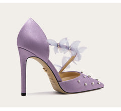 Lavender high-heeled shoe with decorative elements on a light background