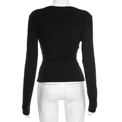 Black long-sleeve top on a white mannequin with a white background