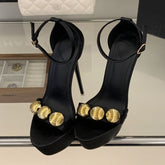 Platform stiletto sandal in black with gold embellishments