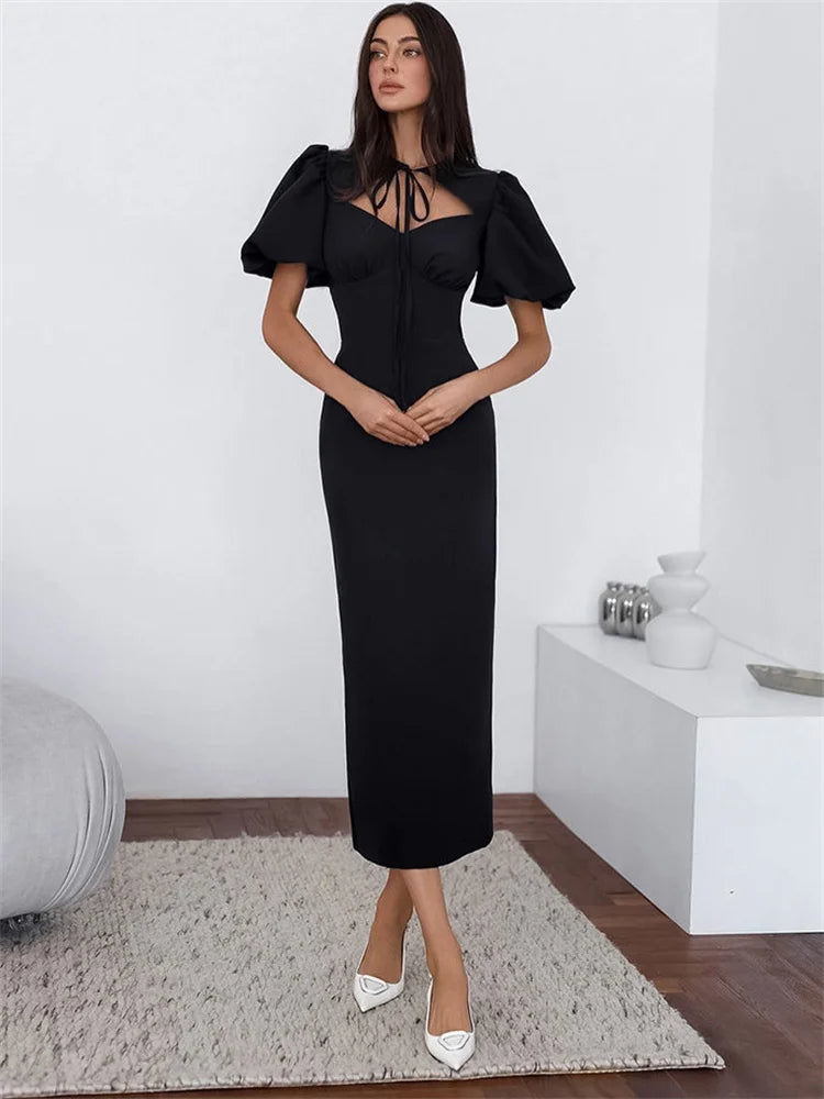 Woman wearing a black dress in a minimalistic room
