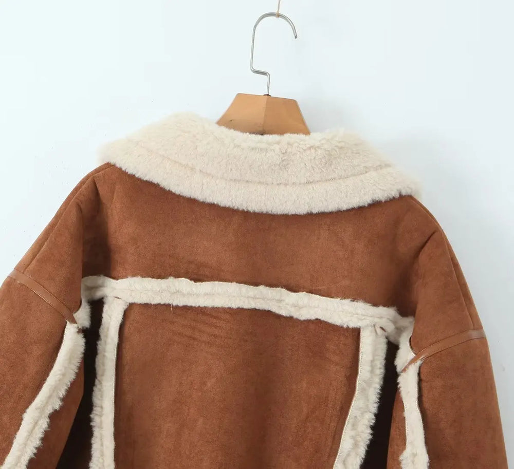Brown coat with white fur trim on a wooden hanger against a white background