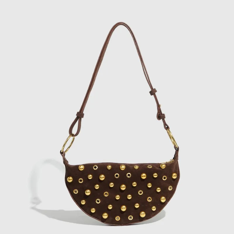 Brown handbag with gold studs on a light gray background
