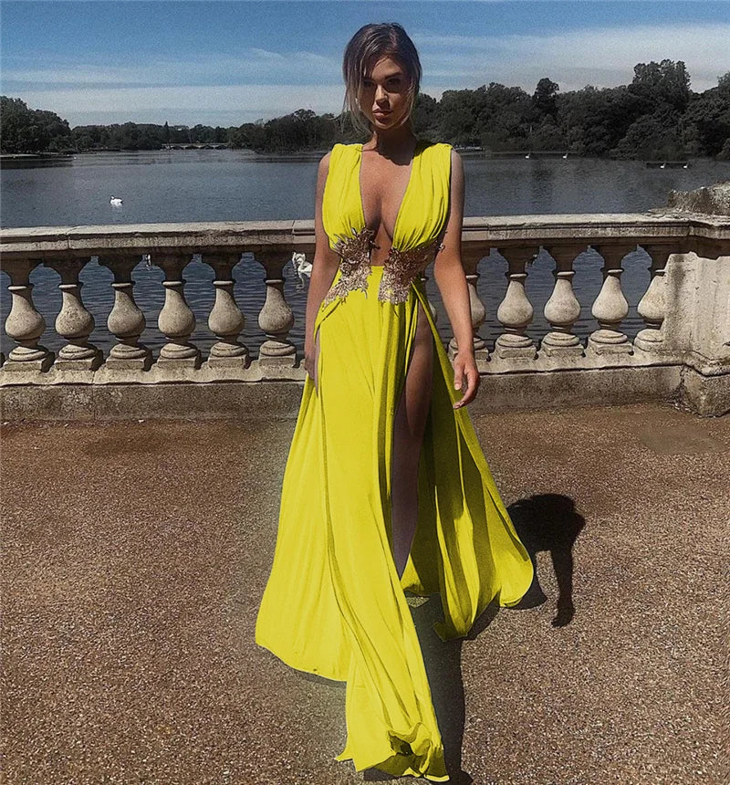 Woman in a bright yellow dress standing outdoors with a scenic background