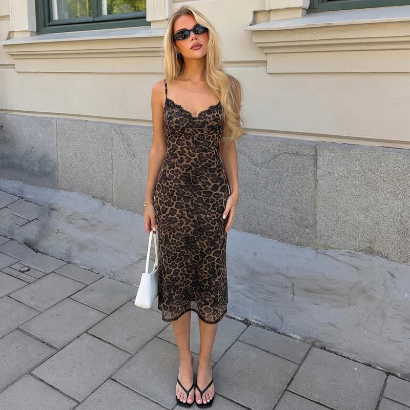 Blonde woman wearing a leopard print lace trim midi dress and black sandals