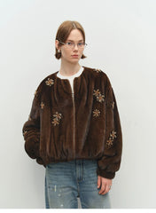Close-up of beading detail on brown faux fur bomber jacket