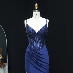 Blue evening gown on a mannequin against a black background