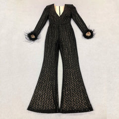 Black beaded jumpsuit with feathered cuffs on a light gray background