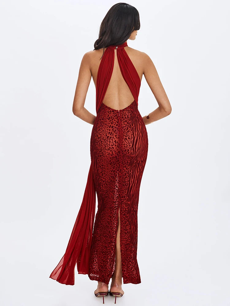 Red evening gown with open back and slit on a white background